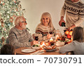 The man fills wine glasses above the festive table 70730791