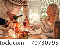 The man fills a wine glass to a happy woman 70730795