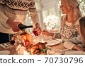 The man fills a wine glass to a woman 70730796