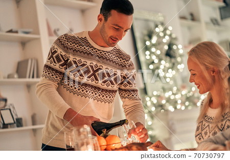 The happy man fills a wine glass The happy man fills a wine glass 70730797