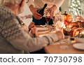 The man fills a glass above the table 70730798