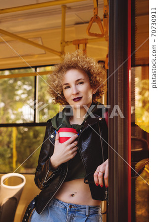 Girl with takeaway coffee 70730911
