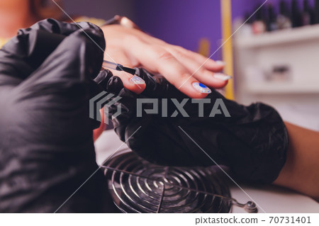 woman doing manicure in a beauty salon. Close-up of hands. woman doing manicure in a beauty salon. Close-up of hands. 70731401
