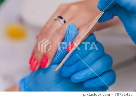 woman doing manicure in a beauty salon. Close-up of hands. 70731433