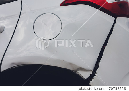 car has dented rear bumper damaged after accident. 70732528