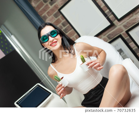 a woman in a laser hair removal Studio poses with a cactus a woman in a laser hair removal Studio poses with a cactus 70732635