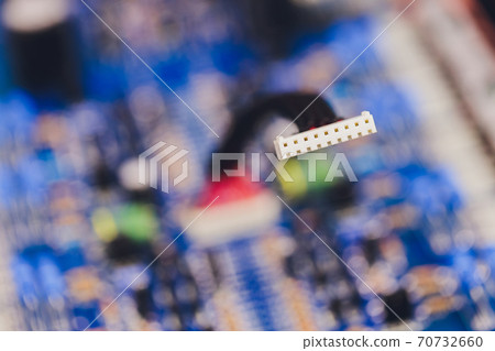 Closeup on electronic board in hardware repair shop, blurred and toned image. Shallow DOF, focus on the middle left field. Closeup on electronic board in hardware repair shop, blurred and toned image. Shallow DOF, focus on the middle left field. 70732660