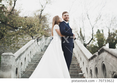 Sensual portrait of a young wedding couple. Outdoor Sensual portrait of a young wedding couple. Outdoor 70733622