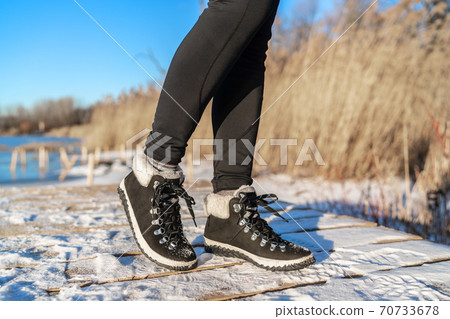 Snow boots fashion footwear for winter season girl wearing black leather ankle shoes 70733678