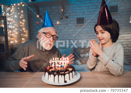 Grandfather and grandson at night at home.  70735547