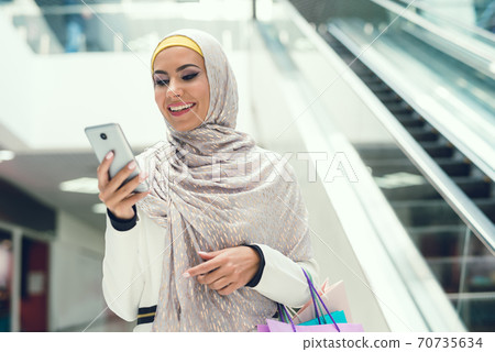 Young Arabian Woman Using Smartphone on Shopping. Young Arabian Woman Using Smartphone on Shopping. 70735634