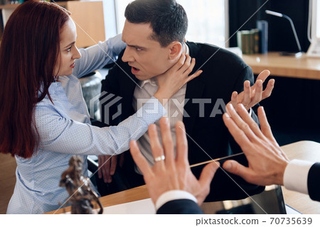 Woman strangles a man with her bare hands. Woman strangles a man with her bare hands. 70735639