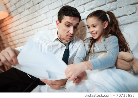 Young father tells his daughter about his work. Young father tells his daughter about his work. 70735655