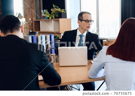 Divorcing couple dissolves marriage contract. Divorcing couple dissolves marriage contract. 70735675