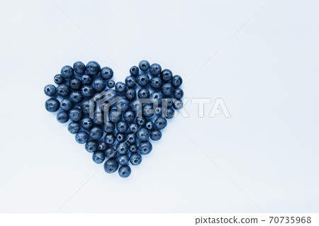 Superfood blueberries formed into a heart shape. Healthy food, summer berries. Minimal food concept. Flatlay. Selective focus. Copy space. 70735968