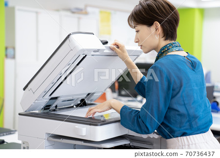 Female employee making a copy 70736437
