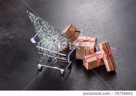 Shopping cart with Christmas gifts and holiday presents Shopping cart with Christmas gifts and holiday presents 70736681