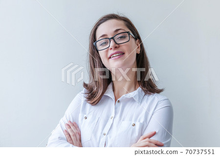 Beautiful happy girl smiling. Beauty simple portrait young smiling brunette woman in eyeglasses isolated on white background. Young european woman portrait, true emotions. Copy space Beautiful happy girl smiling. Beauty simple portrait young smiling brunette woman in eyeglasses isolated on white background. Young european woman portrait, true emotions. Copy space 70737551