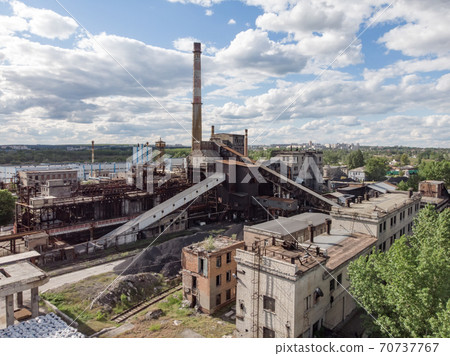 Aerial drone shot of old industrial zone with smoke stack. Air pollution concept Aerial drone shot of old industrial zone with smoke stack. Air pollution concept 70737767