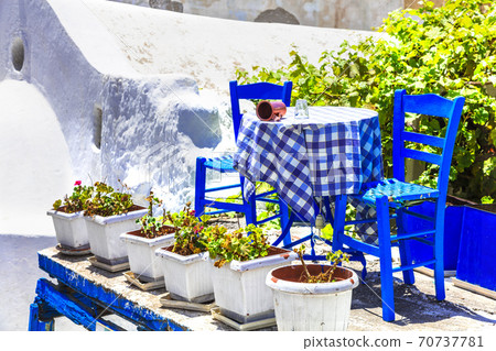 Cute taverns of Greece with typical wooden chairs. Naxos island 70737781