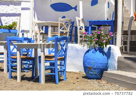 Traditional Greek tavern in the beach side with typical blue chairs. Astypalea island, Greece 70737782