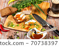 smoked meat lies on the table with herbs and sauce 70738397