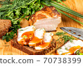smoked meat lies on the table with herbs and sauce 70738399