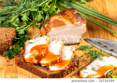 smoked meat lies on the table with herbs and sauce 70738399