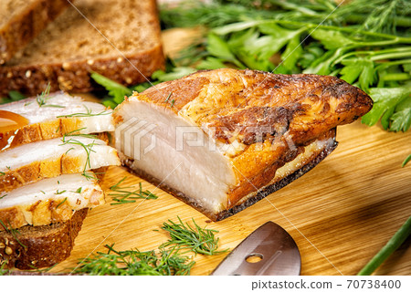 smoked meat lies on the table with herbs and sauce 70738400