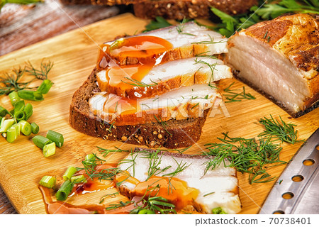 smoked meat lies on the table with herbs and sauce 70738401