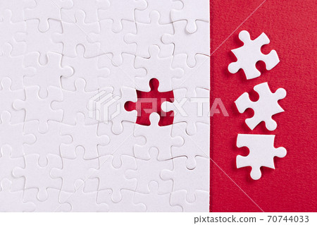 Plain white jigsaw puzzle, on Red background Plain white jigsaw puzzle, on Red background 70744033