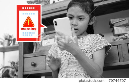 Image of a child whose smartphone is infected with a virus Image of a child whose smartphone is infected with a virus 70744707