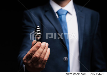man in a suit holds an anal plug in his hand for sex 70745678