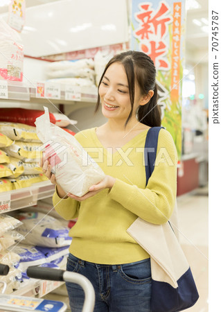 Young woman shopping at a supermarket Young woman shopping at a supermarket 70745787