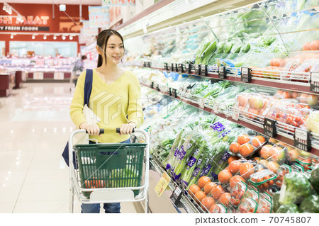 Young woman shopping at a supermarket Young woman shopping at a supermarket 70745807
