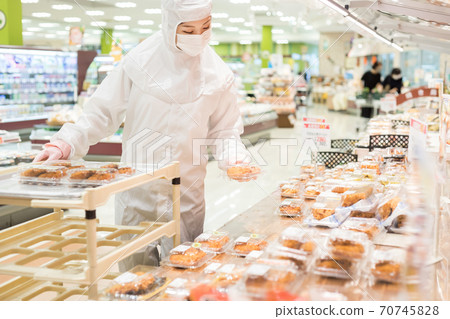 People working behind the supermarket 70745828