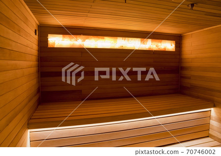 Empty wooden sauna interior with beutiful warm lightning Empty wooden sauna interior with beutiful warm lightning 70746002