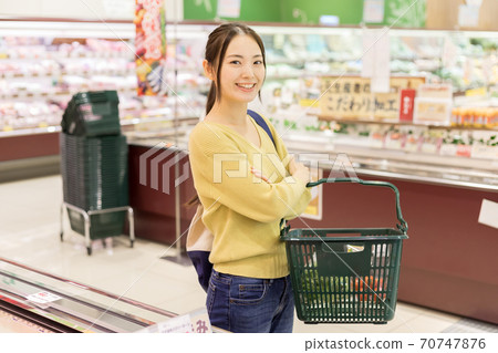 Young woman shopping at a supermarket Young woman shopping at a supermarket 70747876