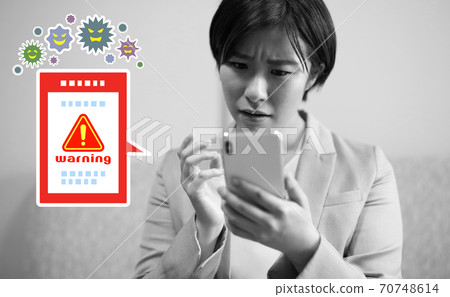 Image of a female office worker who is in trouble because her smartphone is infected with a virus Image of a female office worker who is in trouble because her smartphone is infected with a virus 70748614