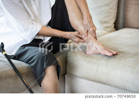 Achilles tendinitis,painful of leg and ankle in joint of the bone,senior woman suffer from plantar fasciitis,tendon connecting calf muscles to the heel,injury to stiffness of the ligaments in the body 70749650