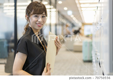Business person trying to post a document to a mailbox 70750556