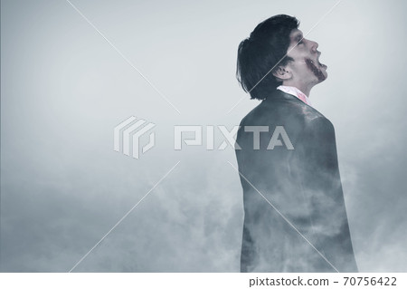 Scary zombie with blood and wound on his body standing 70756422