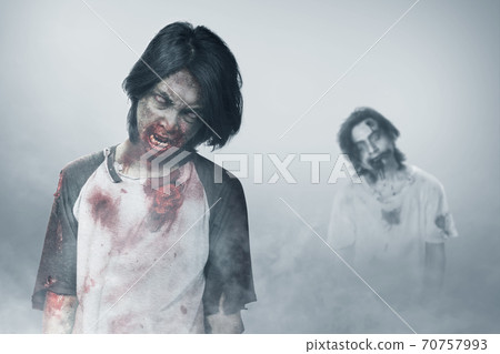 Scary zombie with blood and wound on his body standing Scary zombie with blood and wound on his body standing 70757993