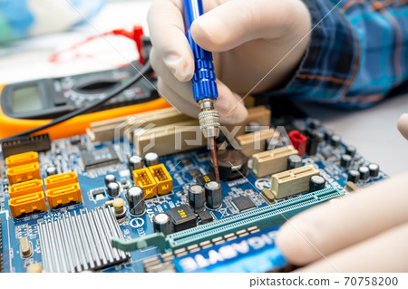 technician repairing inside of hard disk by soldering iron. Integrated Circuit. the concept of data, hardware, technician and technology. 70758200