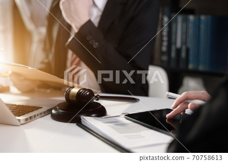 Business people and lawyers discussing contract papers sitting in the table at office in the morning. concepts of law, advice, legal services. 70758613