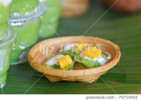 Green coconut sweet pudding and corn. Thai traditional dessert. Green coconut sweet pudding and corn. Thai traditional dessert. 70759302