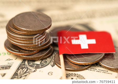Stack of coins with Switzerland flag on USA America dollar banknotes. Stack of coins with Switzerland flag on USA America dollar banknotes. 70759411