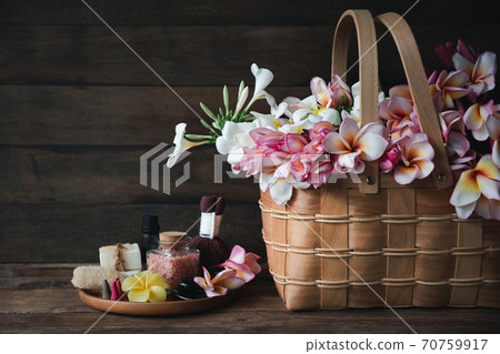 Spa products with organic soap luffa scrub compress ball,pink salt,black stones and beautiful flower on wooden tray isolated on white background with clipping path. Spa products with organic soap luffa scrub compress ball,pink salt,black stones and beautiful flower on wooden tray isolated on white background with clipping path. 70759917