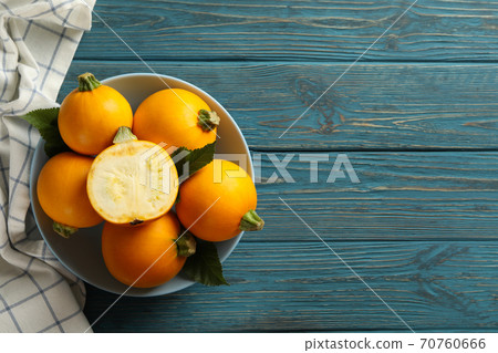 Bowl with round zucchini and napkin on wooden table Bowl with round zucchini and napkin on wooden table 70760666