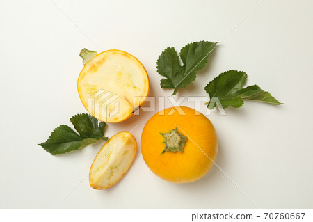 Round zucchini and leaves on white background Round zucchini and leaves on white background 70760667